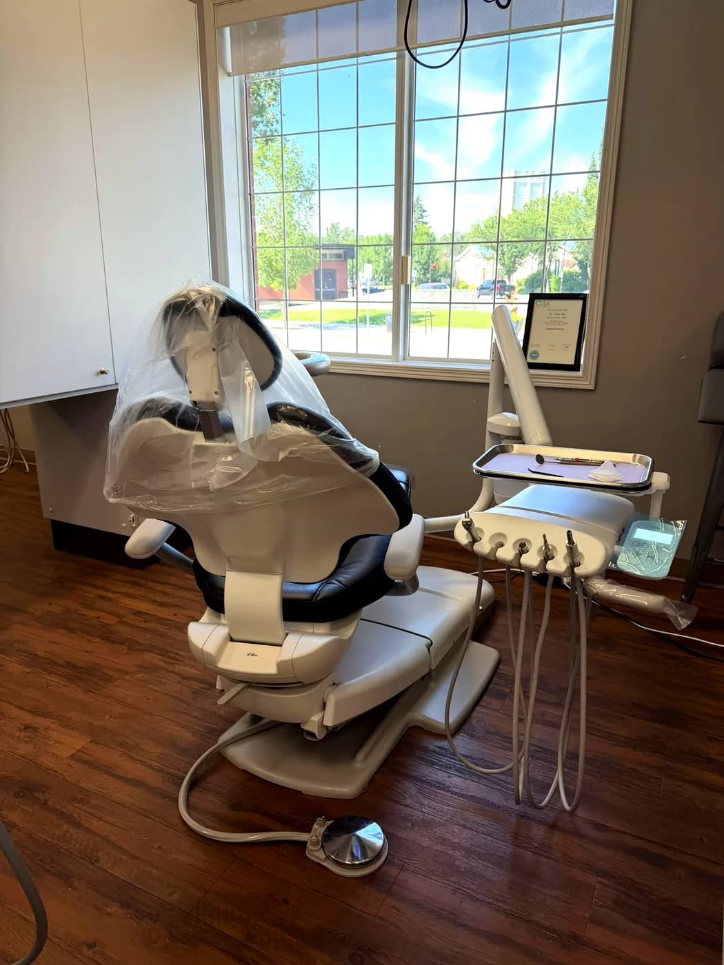 A treatment room at High River Dental Centre with a modern A-dec dental chair beside a bright window