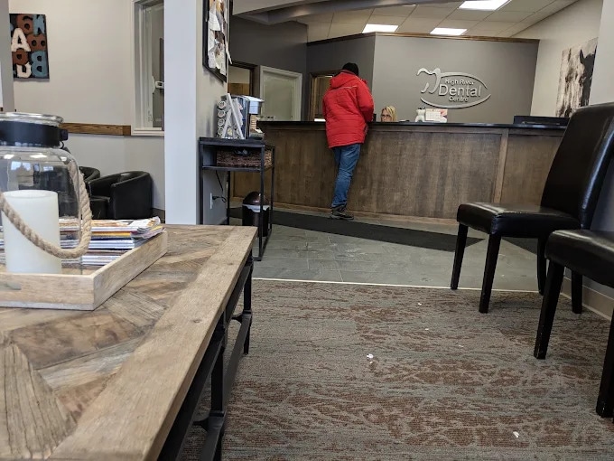 Patient checking in at the High River Dental Centre front desk, seen from the waiting area