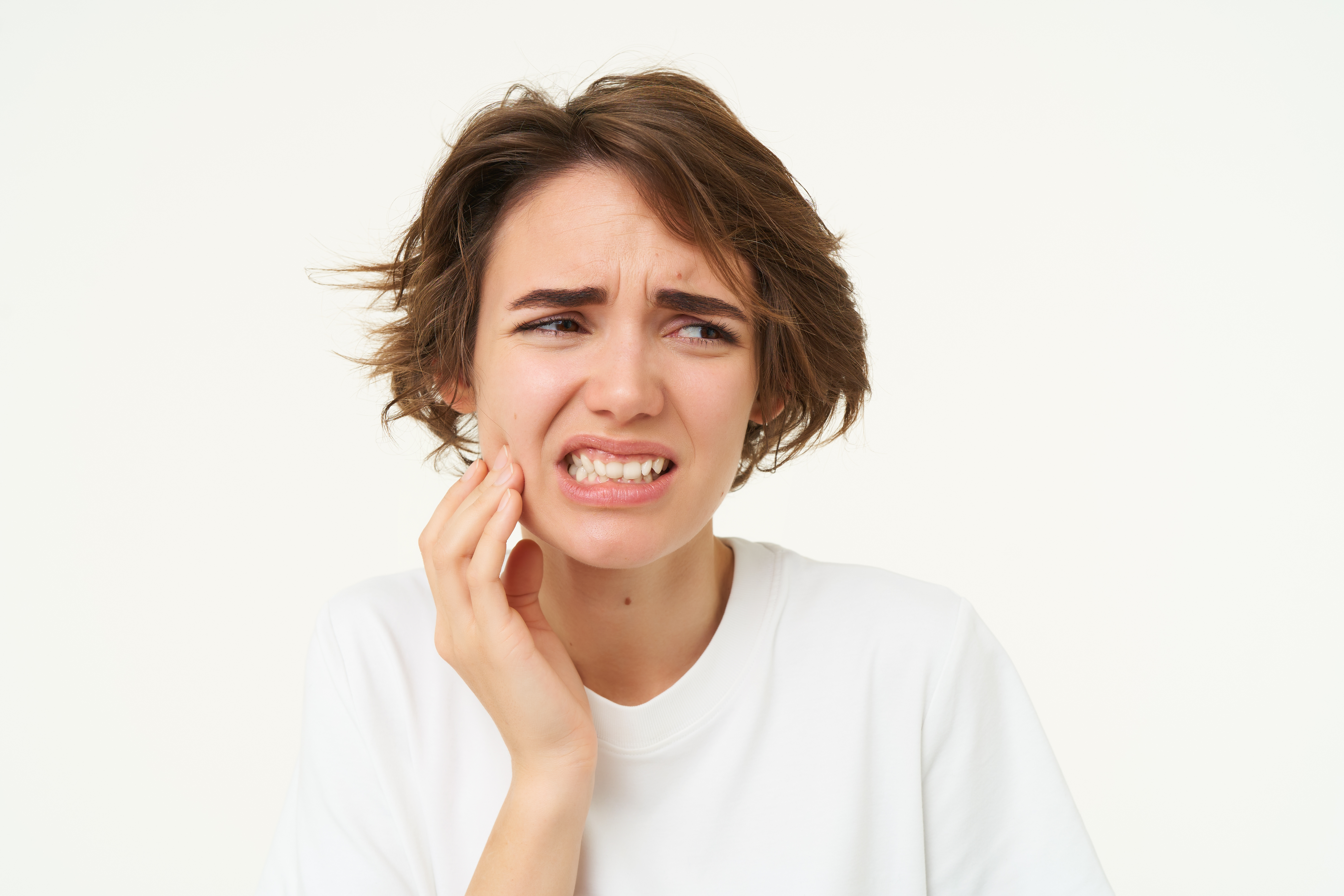 Patient receiving urgent dental care from a calm, focused dentist