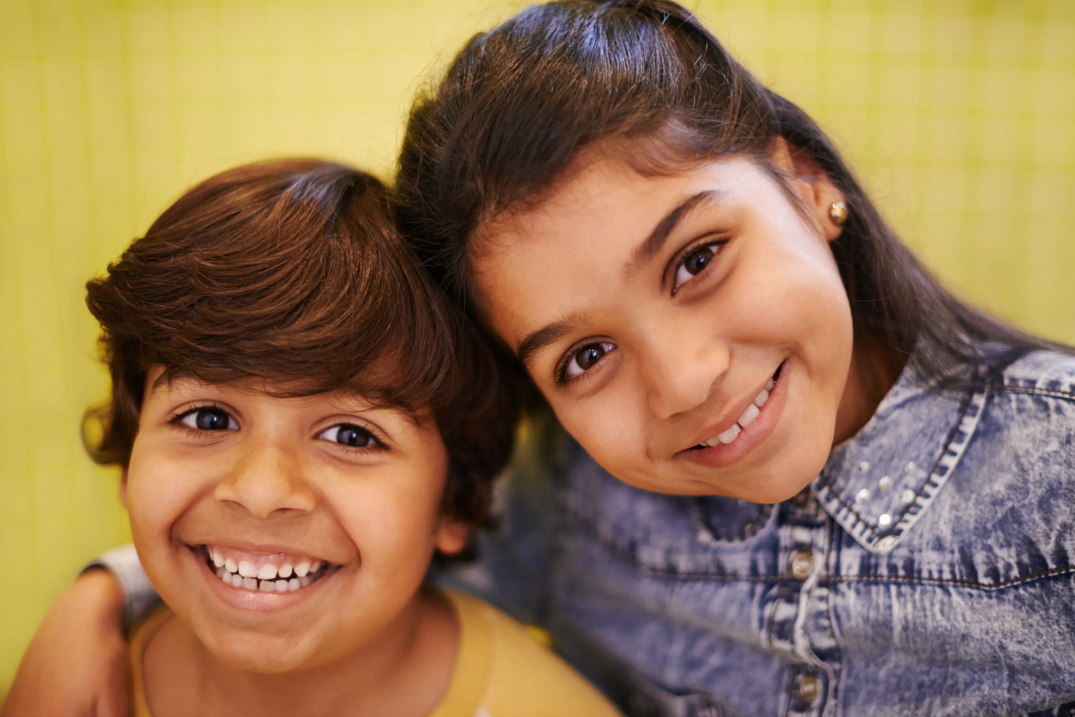 Two smiling siblings, happy kids dental visit